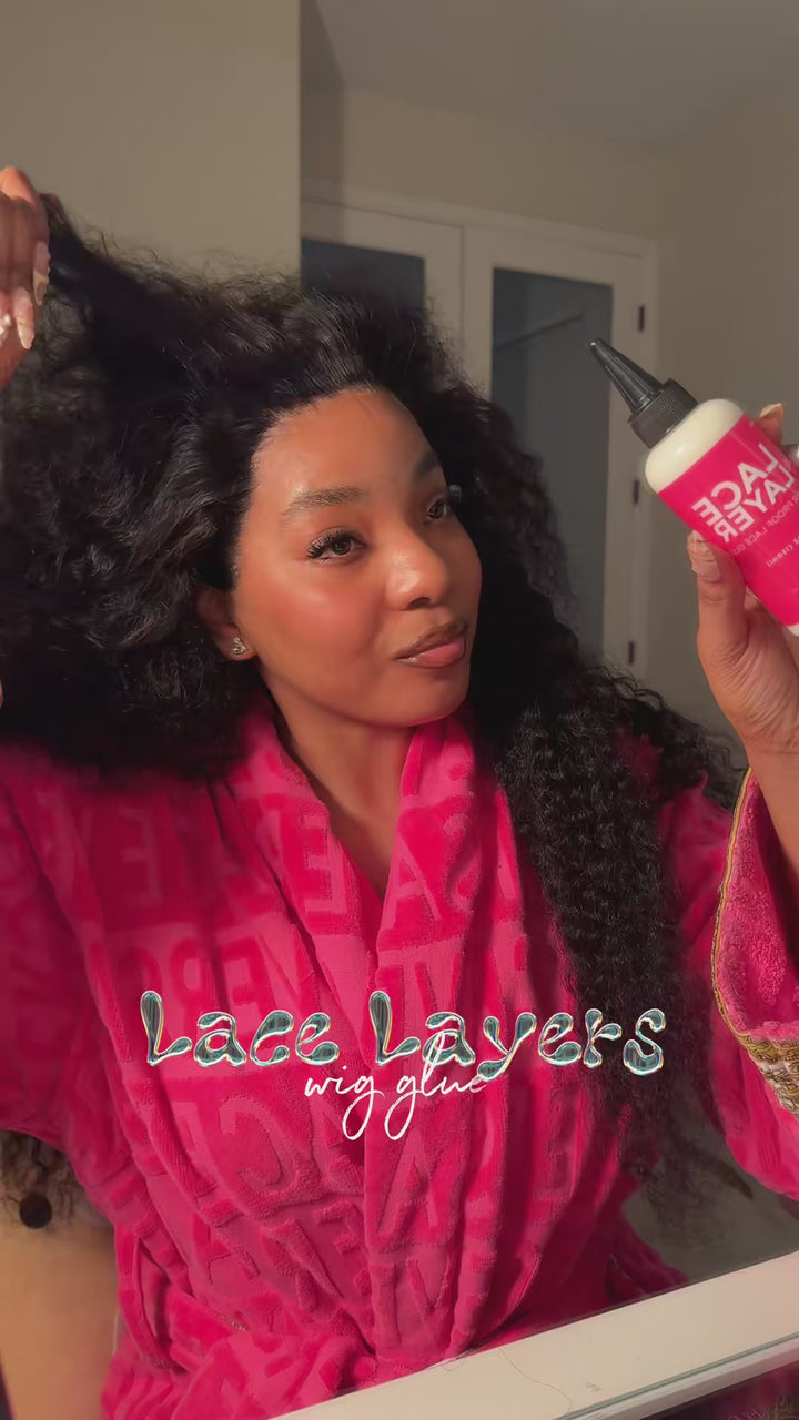 Person applying LaceLayer Plus pro-size waterproof lace glue to a wig install for a secure, invisible hold.